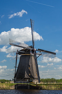 gray windmill near body of water thumbnail