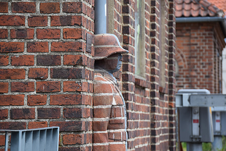 man wearing brown cap leaning on wall thumbnail