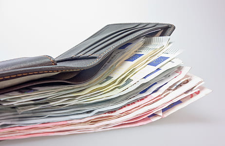 assorted banknotes on brown leather wallet thumbnail