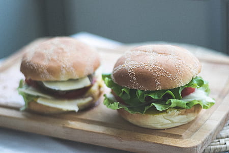 two burgers on wooden tray thumbnail