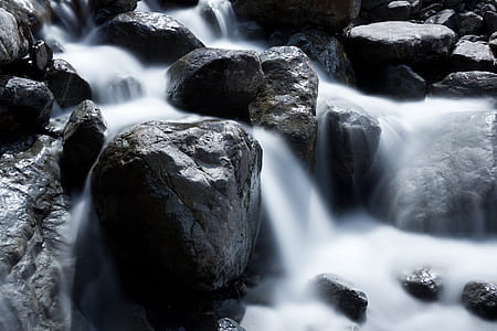 water flows on rock at daytime thumbnail