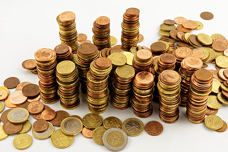 pile of coins on white surface thumbnail