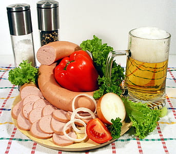 sausage, tomato, and vegetable on plate beside glass mug thumbnail