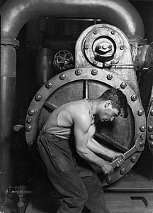 man wearing tank top and black pants holding wrench tool thumbnail