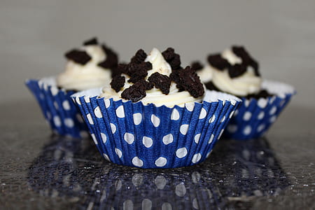 three cupcakes topped with chocolates thumbnail