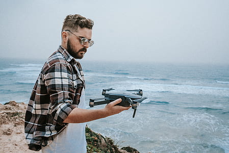 man holding black drone thumbnail