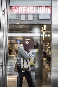 man standing near clear glass door thumbnail