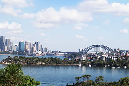 concrete buildings beside body of water thumbnail