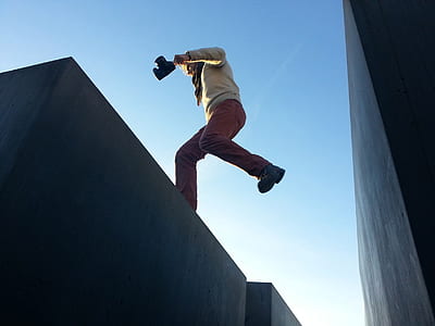 person jumping between two concrete walls thumbnail