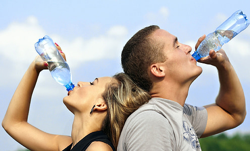 woman and man drinking bottled water thumbnail