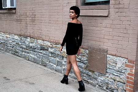 woman wearing black off-shoulder long-sleeved bodycon dress walking on the street thumbnail