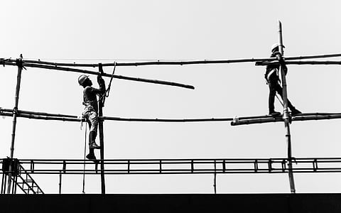two men on scaffolding under sunny sky thumbnail