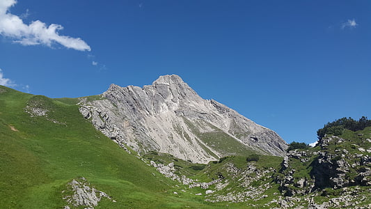 mountain covered with green grass under blue sky landscape photography thumbnail