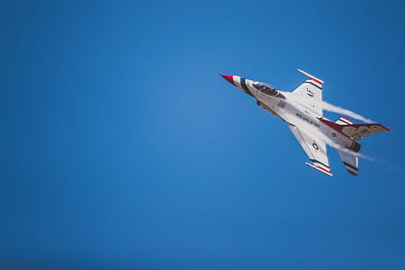 white and red flying jet plane thumbnail