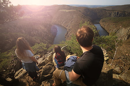 People on Top of Cliff With Water at the Bottom during Daytime thumbnail