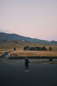 person standing near stop signage thumbnail