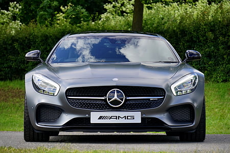 gray Mercedes-Benz AMG parked on concrete pavement near green bush thumbnail