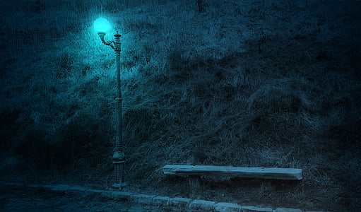 white lighted pole on grass field thumbnail