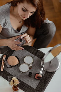 Young beautiful woman doing her make up thumbnail