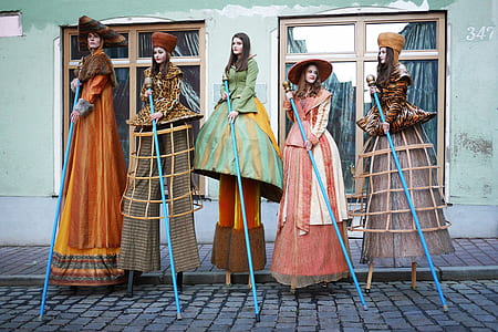 photo of five women holding blue sticks thumbnail