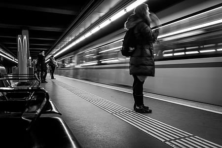 woman standing near passing train thumbnail