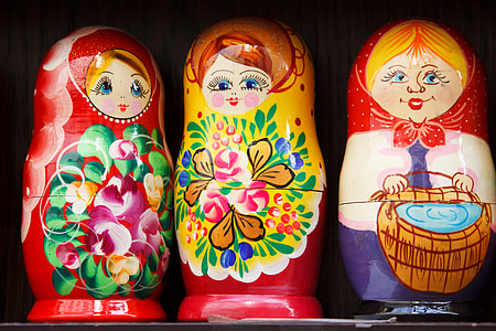 three assorted-color nesting dolls thumbnail
