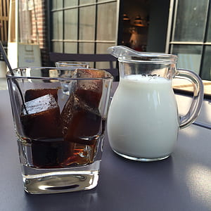 clear glass pitcher filled with milk thumbnail