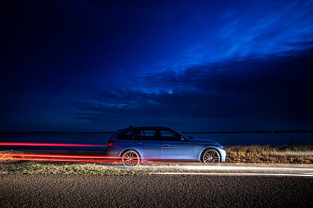 timelapse photography of blue SUV under blue sky thumbnail
