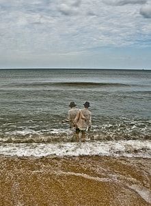 surrealism photograph of man walking towards sea thumbnail