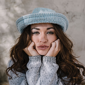 woman wearing blue hat and gray sweater thumbnail