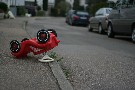 red vehicle ride-on toy on road thumbnail