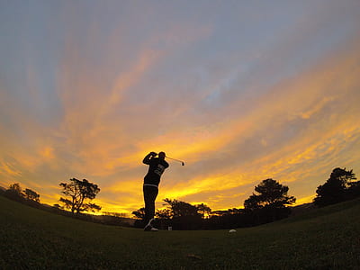man playing golf during sunset thumbnail
