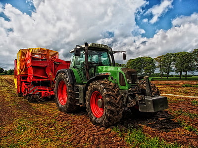 green tractor with red and yellow farm trailer thumbnail