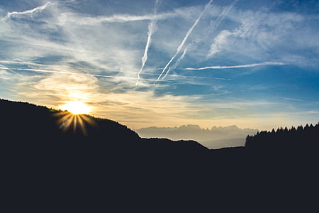 silhouette of mountain and sun thumbnail