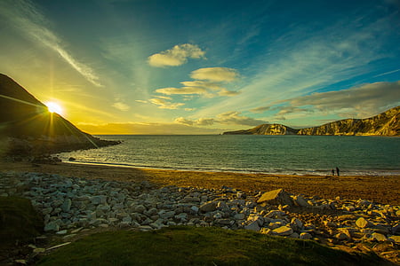 brown sandy beach under blue dawn sky thumbnail