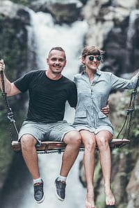 Man Wearing Black Crew-neck Top Riding Swing thumbnail