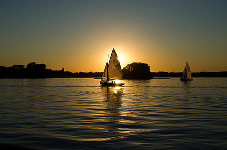 two sailboats near island during golden hour thumbnail
