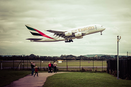 people watching Fly Emirates plane flying during daytime thumbnail