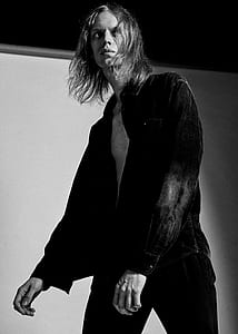 grayscale photography of man wearing opened button-up shirt thumbnail