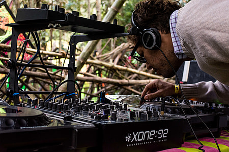 man controlling Xone 92 DJ turntable thumbnail