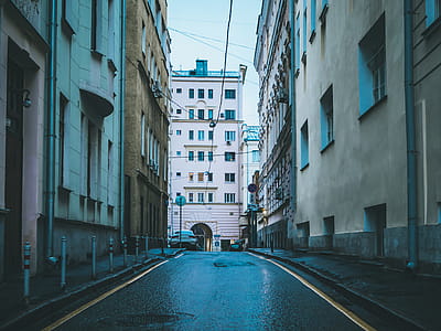 Street Alley With Assorted-color Concrete Buildings thumbnail