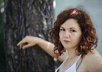 woman putting her hand on tree thumbnail