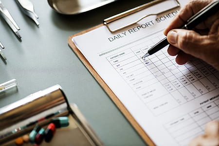 person filling up daily report schedule thumbnail