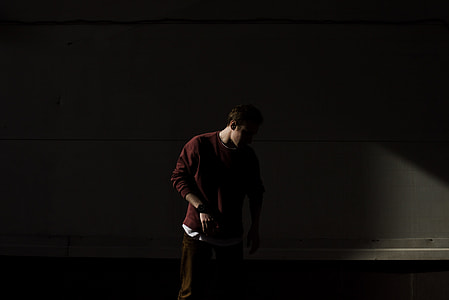 man standing in front of white wall thumbnail