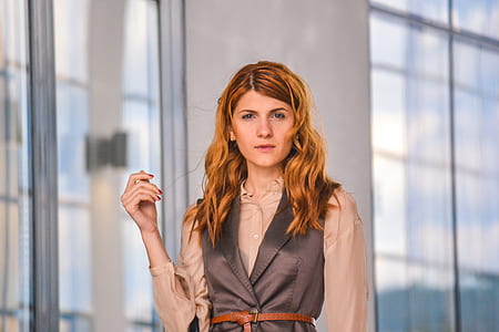 selective focus photography of woman wearing brown and gray collared button-up top thumbnail