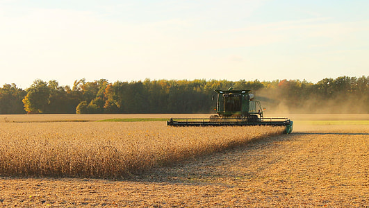 green cultivator under cloudy sky during daytime thumbnail