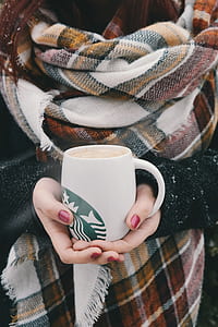 woman holding white Starbucks ceramic coffee mug at daytime thumbnail