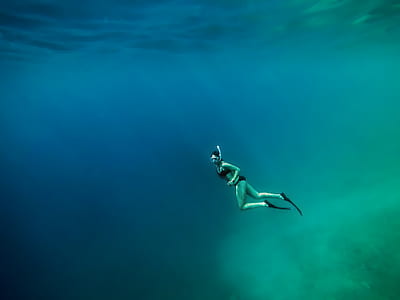 woman diving in body of water thumbnail