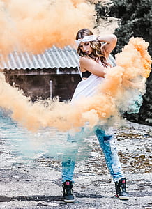 woman holding a orange smoke bottle thumbnail