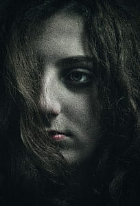 woman looking on side with one cover with hair thumbnail